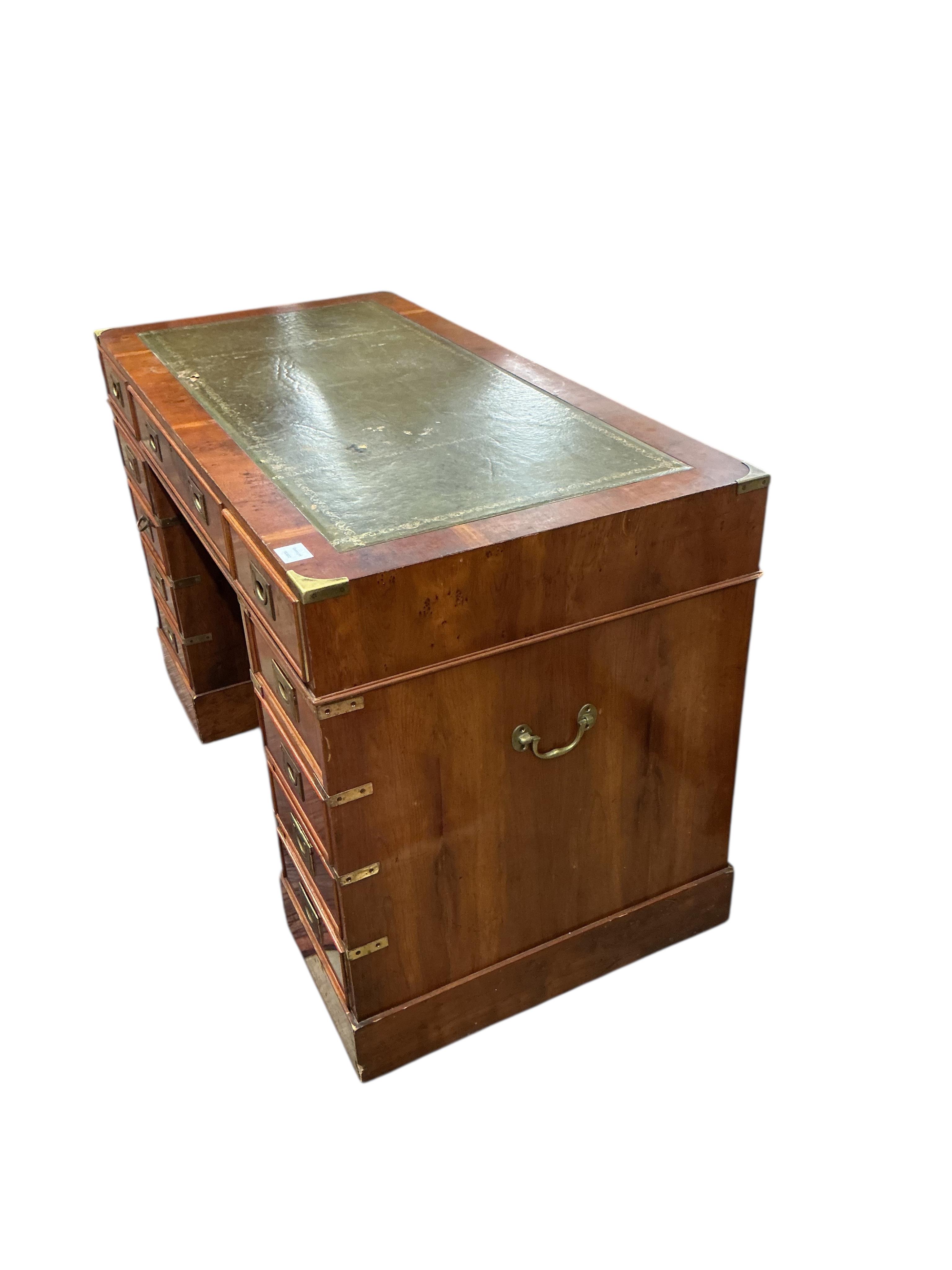 A reproduction brass mounted yew pedestal desk, width 121cm, depth 60cm, height 76cm